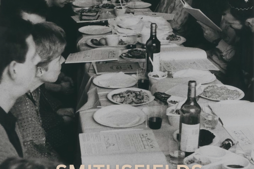 Black and white photo of people around a dinner table