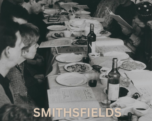 Black and white photo of people around a dinner table