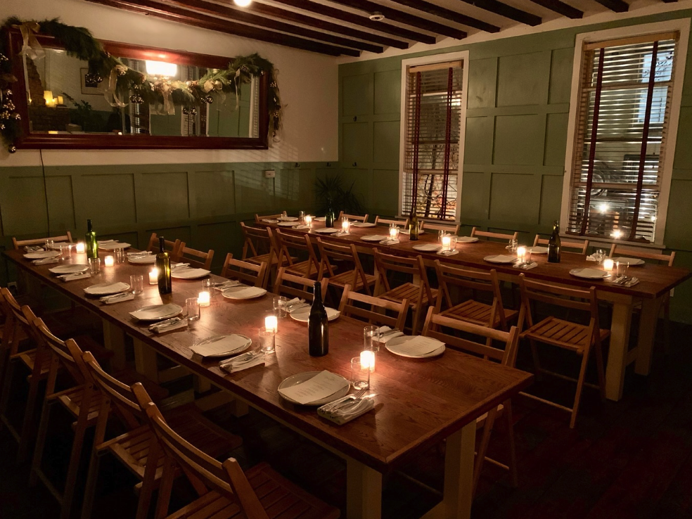 Two long tables set up for a large group dinner