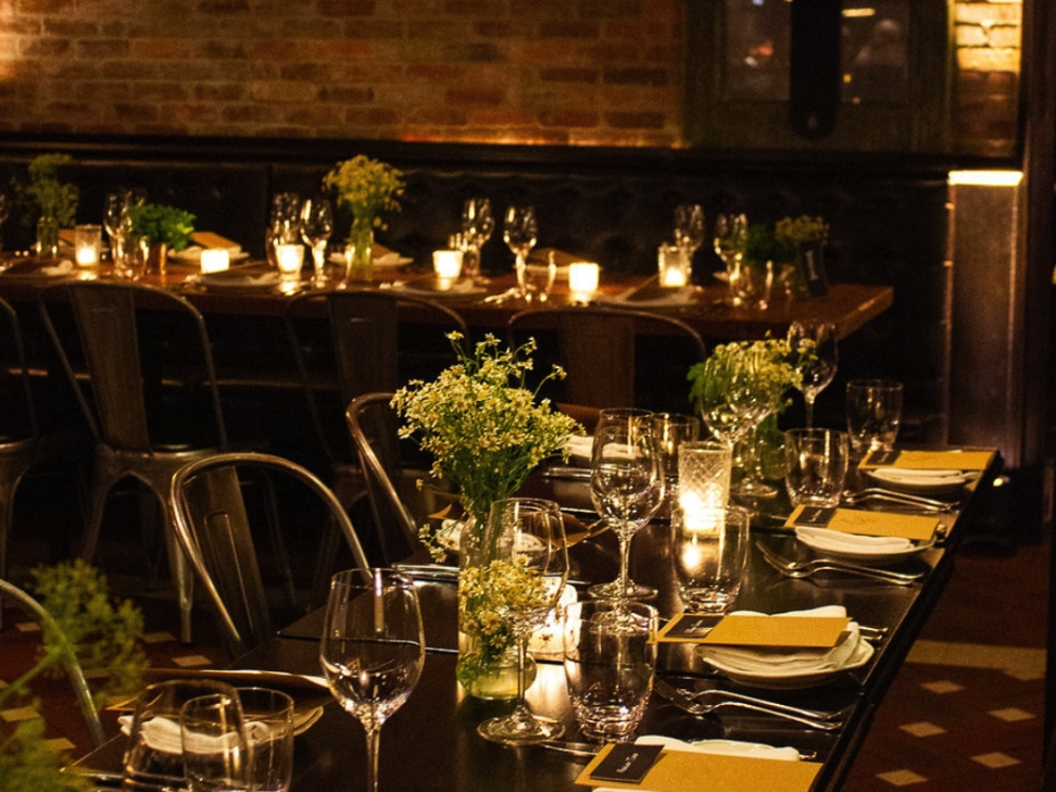 Table setup with flowers and candles in a private dining space