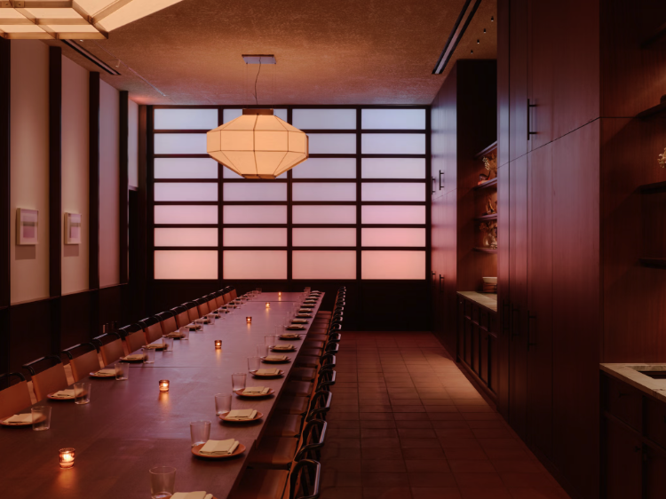 Long table setup in a private dining space with candles