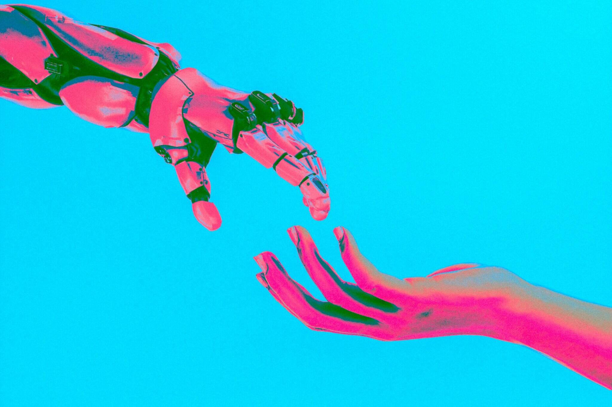 A robot hand moving towards a human hand
