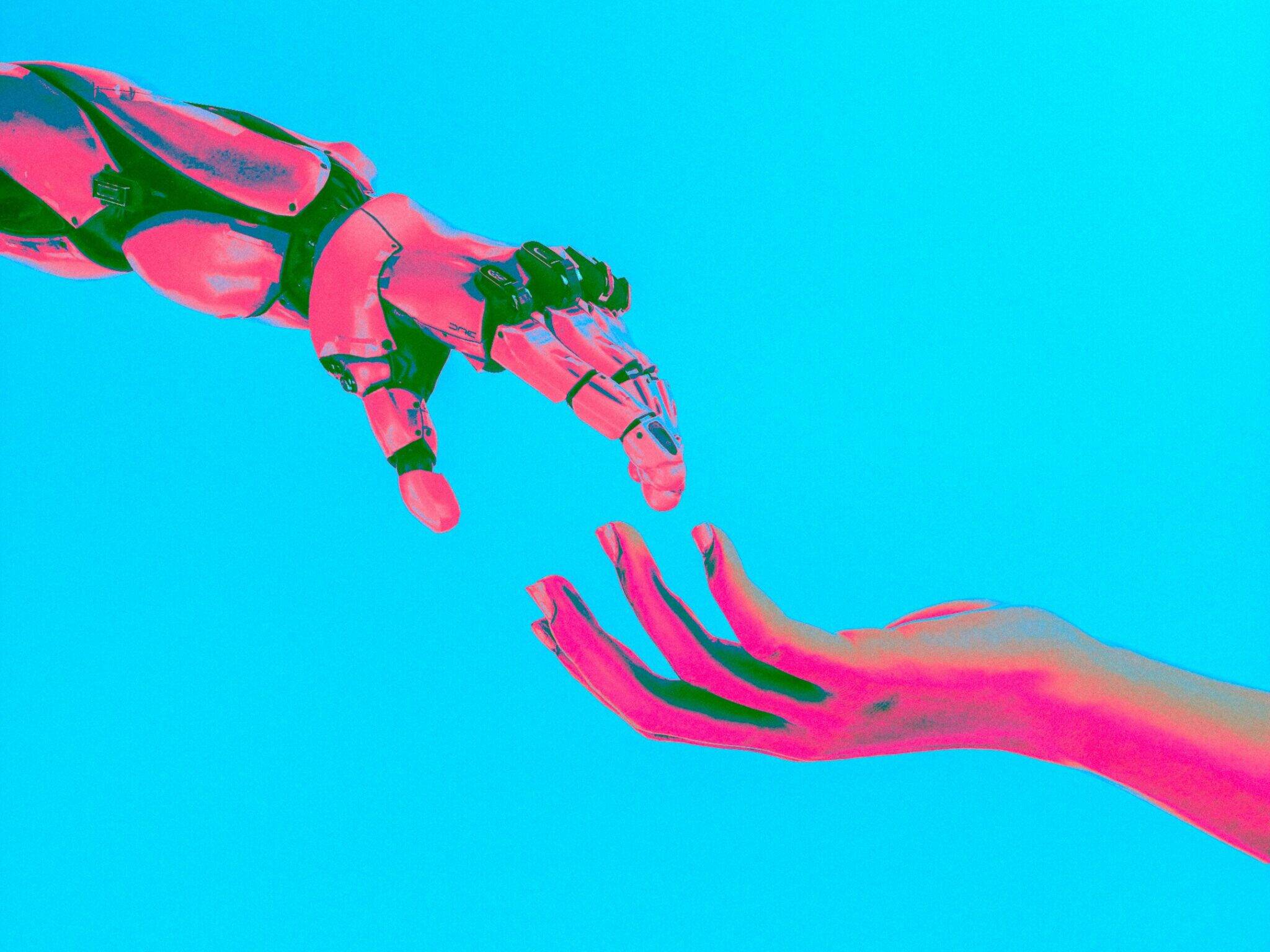 A robot hand moving towards a human hand