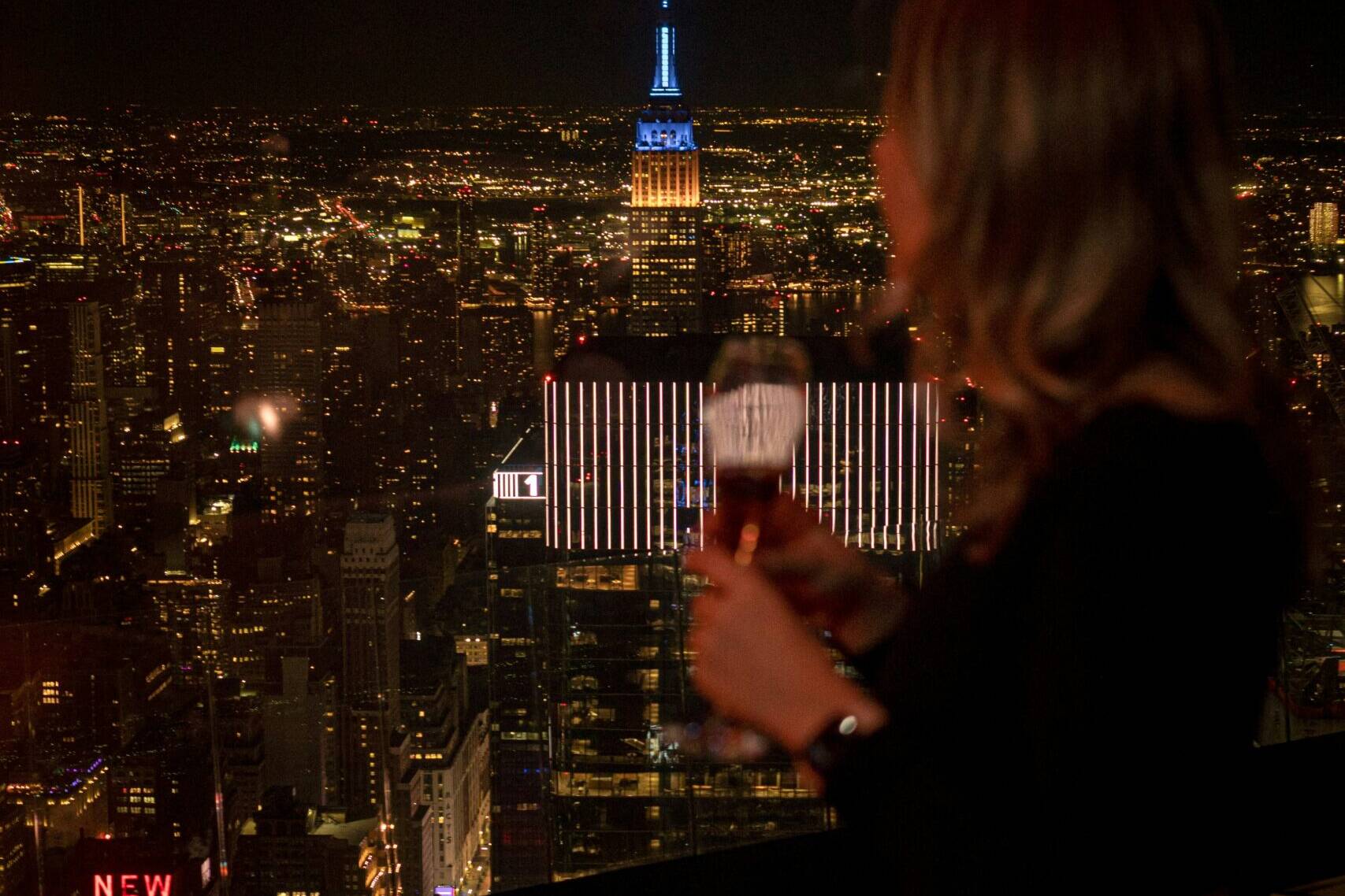 Woman on a rooftop looking over new york city