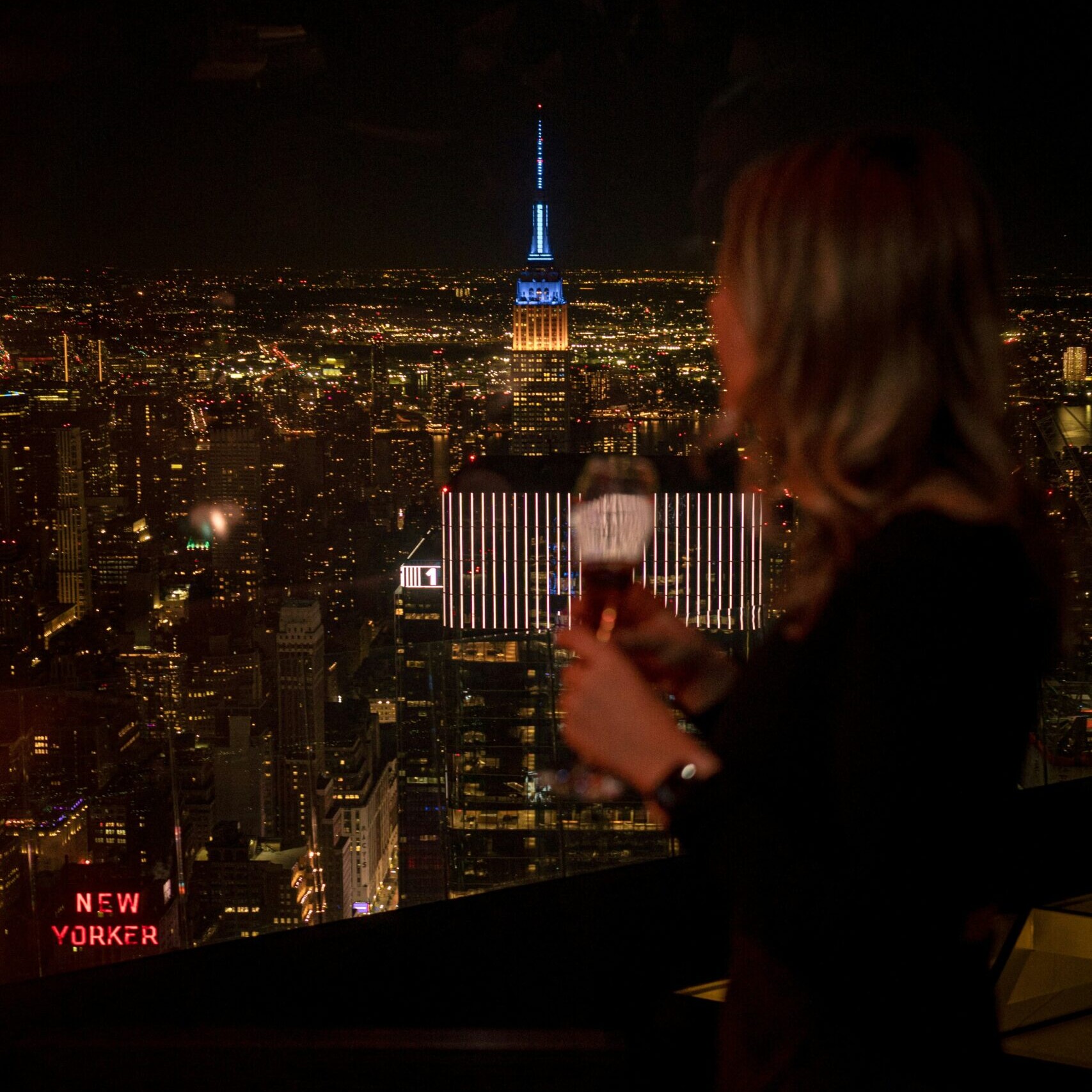 Woman on a rooftop looking over new york city